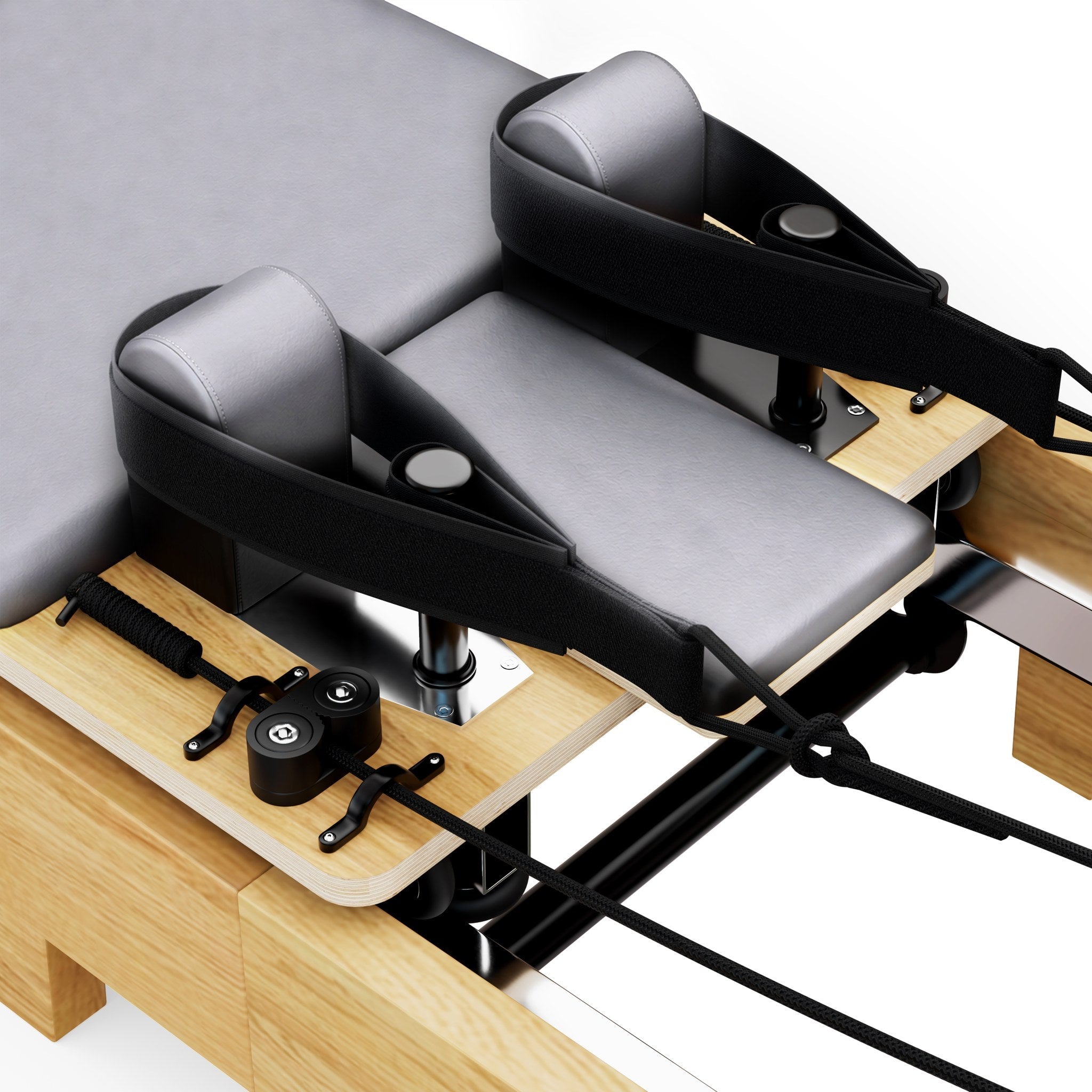 Gepolsterte graue Schulterstützen und Fussschlaufen des TWHEELS Pilates Reformer